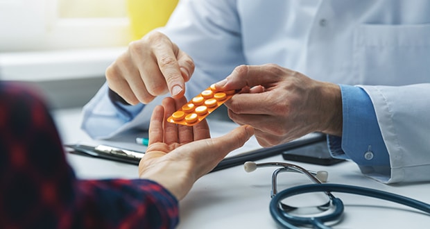 physician consulting female patient about pills. doctor prescribing medicine sitting at the desk in the clinic office Deprescribing at Ambrosia Behavioral Health in Florida